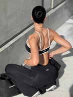 Front View of Black Tempo Minimal Bralette 2.0, featuring removable pads and adjustable straps for low impact all day wear