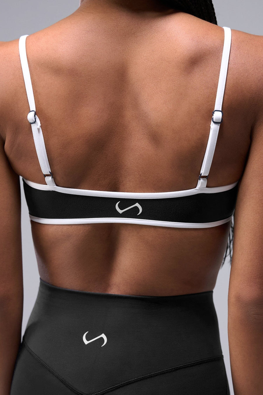 Front View of Black Tempo Minimal Bralette 2.0, featuring removable pads and adjustable straps for low impact all day wear