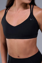 Front View of Black TLF Tempo Strappy Back Sports Bra, featuring a minimal design for the gym and lifestyle wear 
