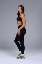Black TLF Tempo Strappy Back Sports Bra — product video showing the strappy back design and minimal silhouette