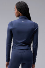 Back View of Blue TLF Tempo Cropped Zip Up Jacket featuring thumbholes and cropped length for gym and lifestyle wear 