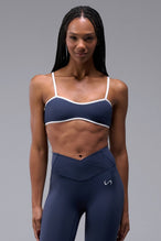 Front View of Blue Tempo Minimal Bralette 2.0, featuring removable pads and adjustable straps for low impact all day wear