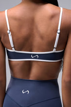 Back View of Blue Tempo Minimal Bralette 2.0, featuring removable pads and adjustable straps for low impact all day wear