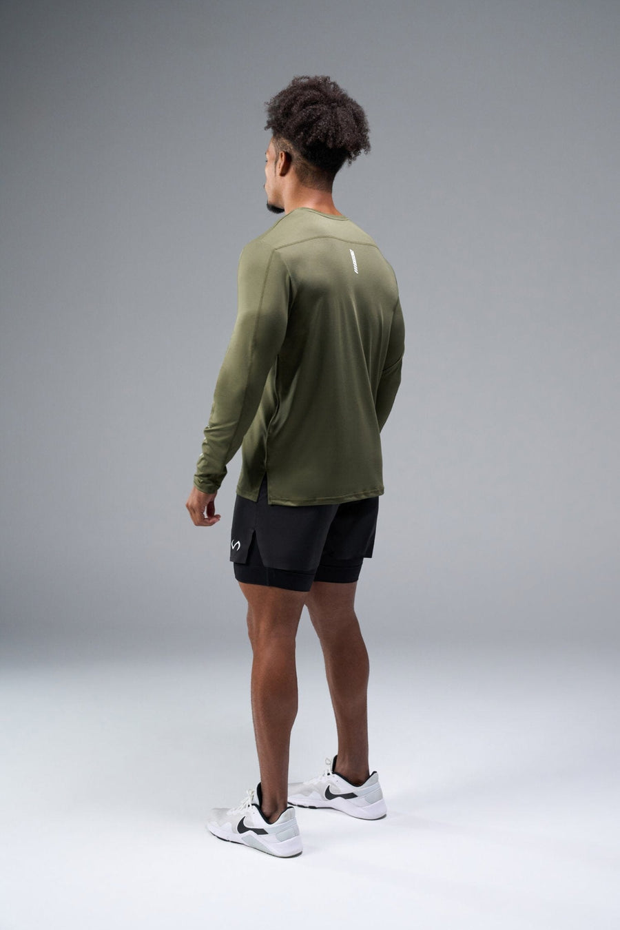 Back View of Green TLF Train Infi-Dry Long Sleeve, featuring our Infi-Dry fabric technology and reflective sleeve design for night running 