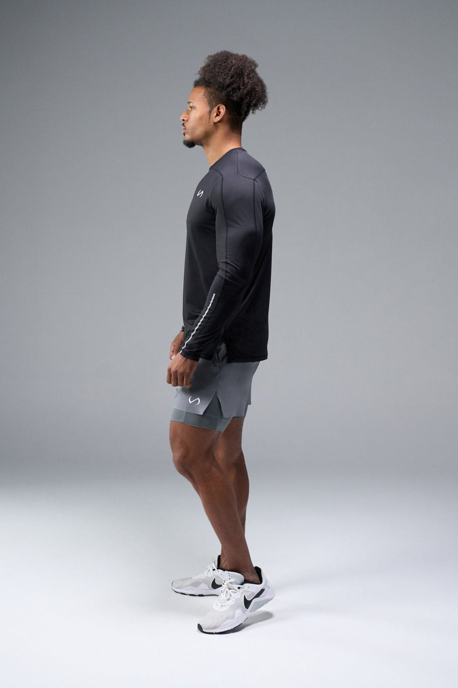Side View of Black TLF Train Infi-Dry Long Sleeve, featuring our Infi-Dry fabric technology and reflective sleeve design for night running 