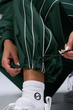 Detail View of Green TLF Baggy Track Pants (Women’s GTS Gym-To-Street Edition) featuring side pockets and reflective piping details.