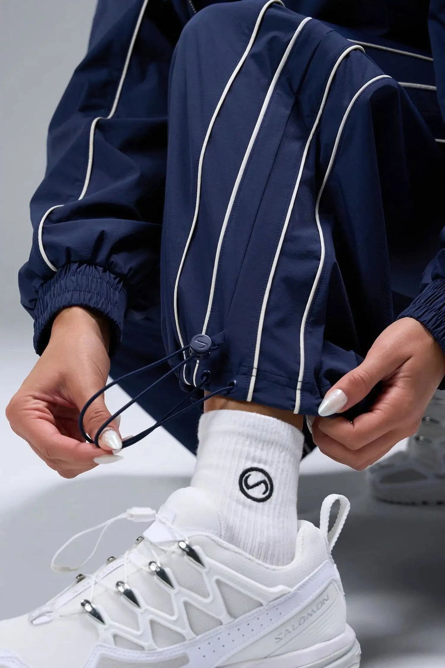 Detail View of Blue TLF Baggy Track Pants (Women’s GTS Gym-To-Street Edition) featuring side pockets and reflective piping details.